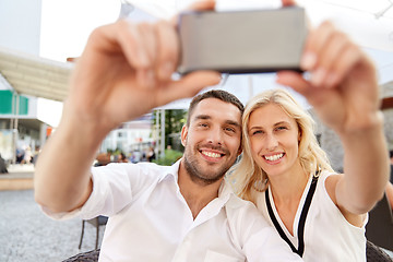 Image showing couple taking selfie with smatphone at restaurant