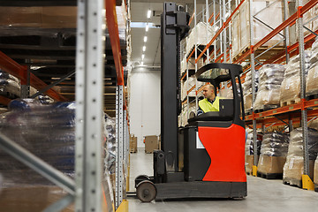 Image showing man on forklift loading cargo at warehouse