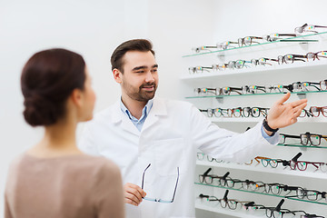 Image showing woman and optician showing glasses at optics store