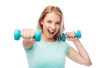 Image showing smiling beautiful young sporty woman with dumbbell