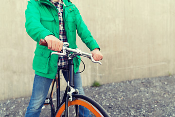 Image showing close up of man with fixed gear bike on street