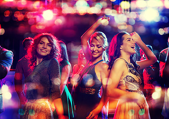 Image showing happy friends dancing in club with holidays lights