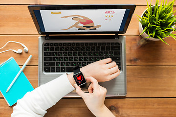 Image showing close up of woman with smart watch and laptop