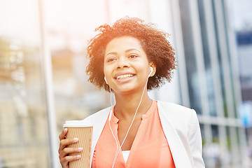 Image showing happy african businesswoman with coffee in city