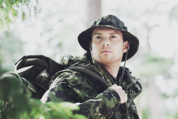 Image showing young soldier with backpack in forest