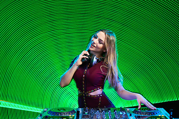 Image showing DJ girl on decks at the party