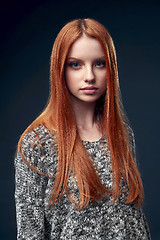 Image showing Beautiful red haired female in grey sweater