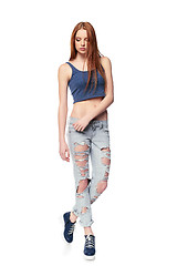 Image showing Modern red haired female wearing distressed jeans