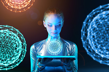 Image showing Cyber woman holding lighting panel with glowing polygonal abstract sphere