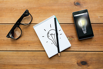 Image showing close up of notepad, smartphone and eyeglasses