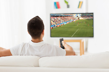 Image showing man watching football or soccer game on tv at home