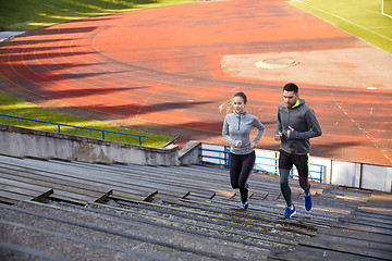 Image showing happy couple running upstairs on stadium