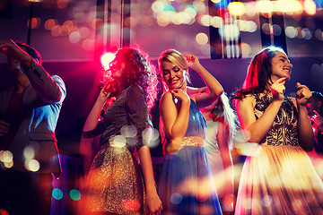 Image showing happy friends dancing in club with holidays lights