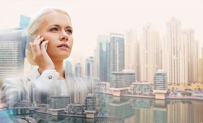 Image showing serious businesswoman with smartphone outdoors