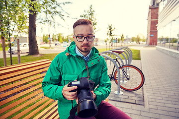 Image showing young hipster man with digital camera in city