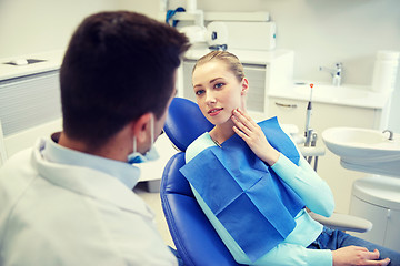 Image showing male dentist with woman patient at clinic