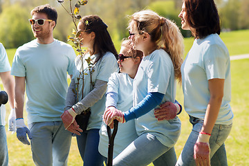 Image showing group of volunteers with trees and shovel in park