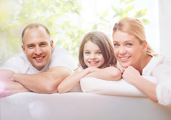 Image showing smiling parents and little girl at home