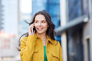 Image showing smiling young woman or girl calling on smartphone