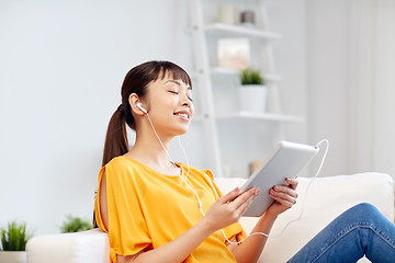 Image showing happy asian woman with tablet pc and earphones