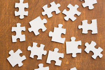 Image showing close up of puzzle pieces on wooden surface