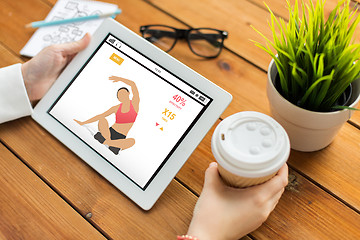 Image showing close up of woman with fitness app on tablet pc