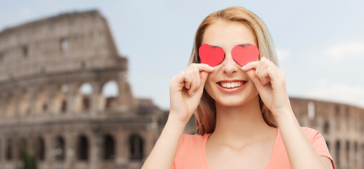 Image showing happy young woman with red heart shapes on eyes