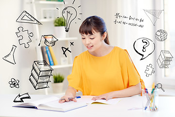 Image showing happy asian young woman student learning at home