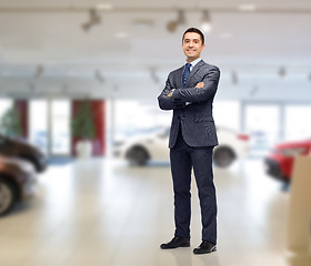 Image showing businessman or car dealer over auto show