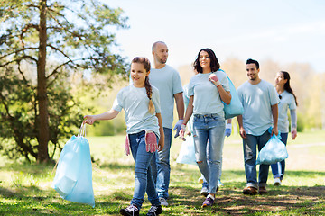 Image showing group of volunteers with garbage bags in park