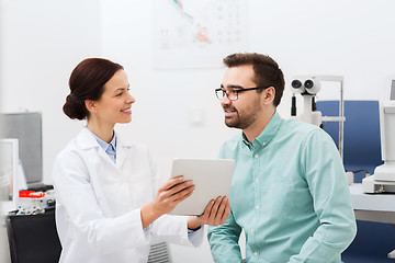 Image showing optician with tablet pc and patient at eye clinic