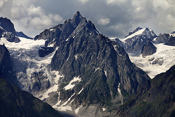 Image showing Mountains with glacier in clouds before rain