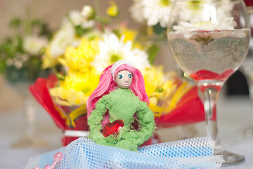 Image showing Spring doll with red heart in hands