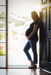 Image showing Chinese Pregnant Woman Standing in Doorway