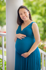 Image showing Portrait of Young Pregnant Chinese Woman on the Front Porch