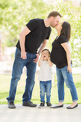 Image showing Young Son Hides Eyes as Pregnant Mommy and Daddy Kiss