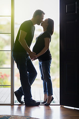 Image showing Mixed Race Pregnant Couple Kissing in Doorway.