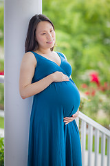 Image showing Portrait of Young Pregnant Chinese Woman on the Front Porch