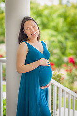 Image showing Portrait of Young Pregnant Chinese Woman on the Front Porch