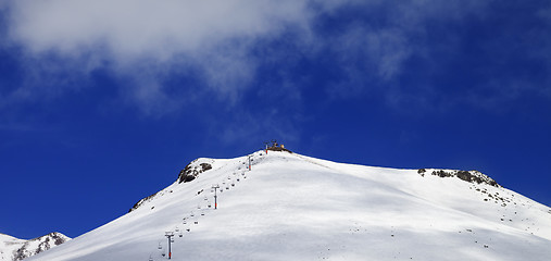 Image showing Panoramic view on ropeway and ski slope in sun day