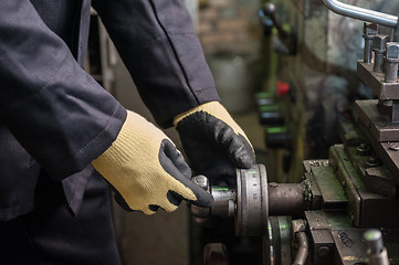 Image showing worker in protective gloves