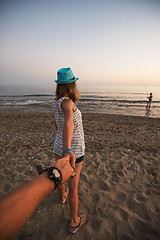 Image showing Girl holding a hand man on the beach