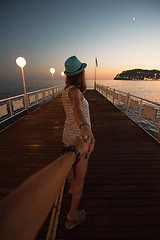 Image showing Girl holding a hand man on the beach