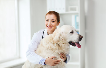 Image showing happy doctor with retriever dog at vet clinic