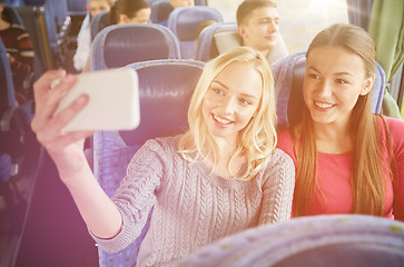 Image showing women taking selfie by smartphone in travel bus