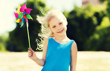 Image showing happy little girl with colorful pinwheel at summer