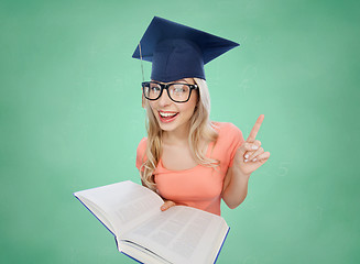 Image showing student woman in mortarboard with encyclopedia