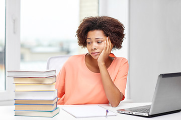 Image showing bored african american woman doing homework home