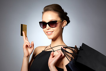 Image showing happy woman with credit card and shopping bags