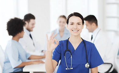 Image showing happy doctor over group of medics at hospital